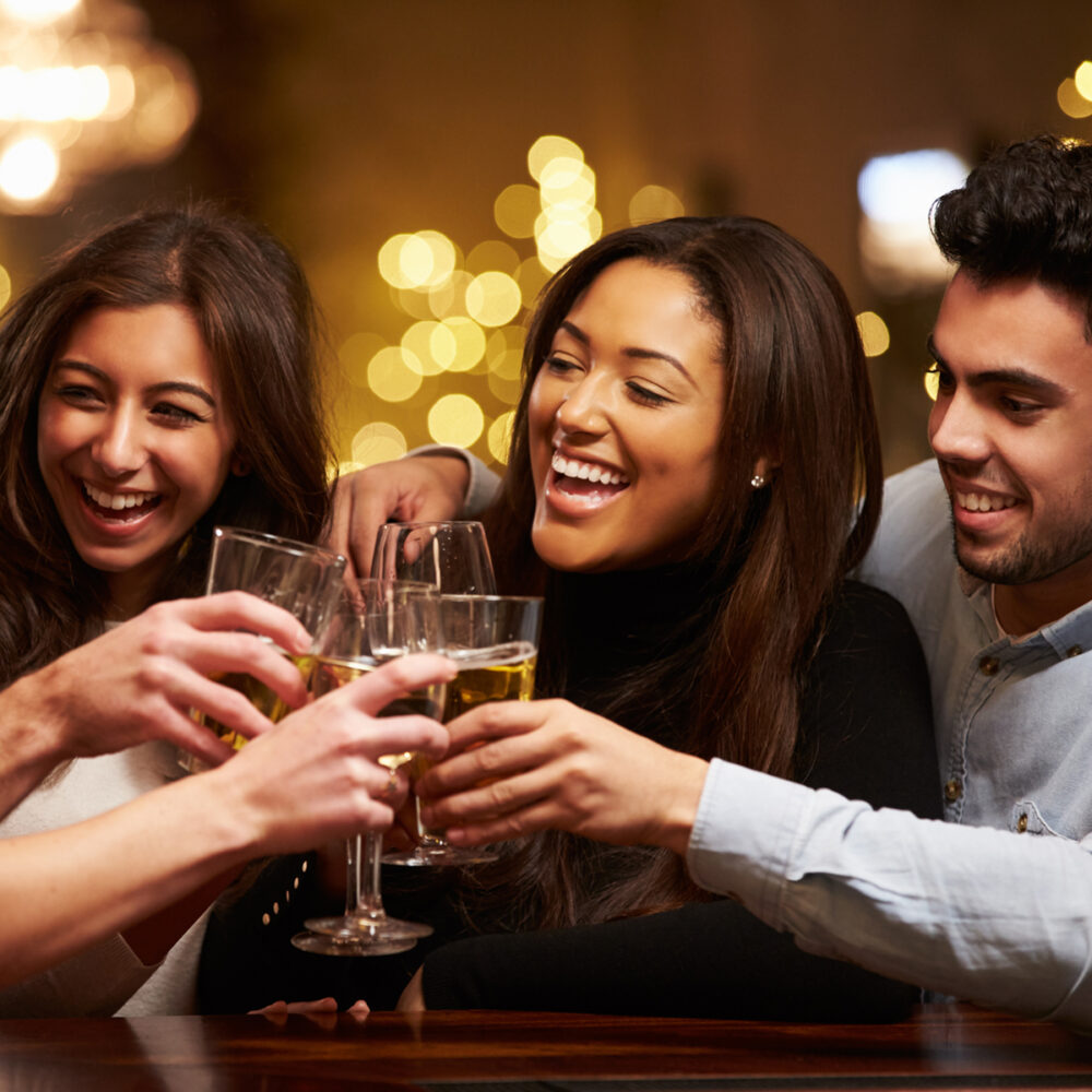 Group Of Friends Enjoying Evening Drinks In Bar